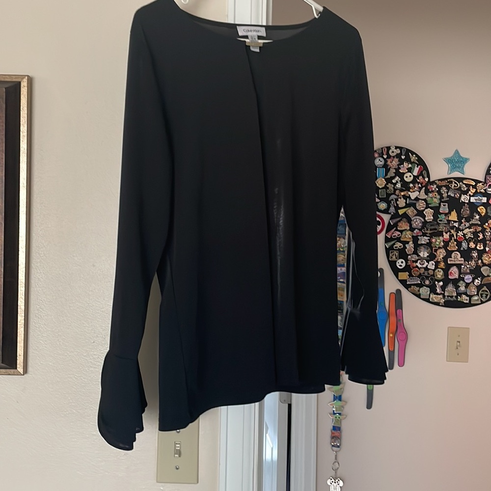 Calvin Klein women’s long sleeve blouse with bell sleeves.